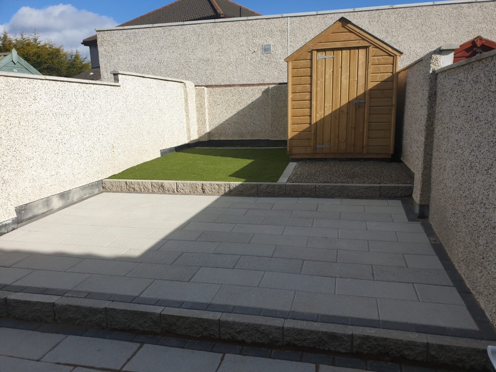 Tiered Granite Patio with Astroturf and Gravel Patch in Dublin
